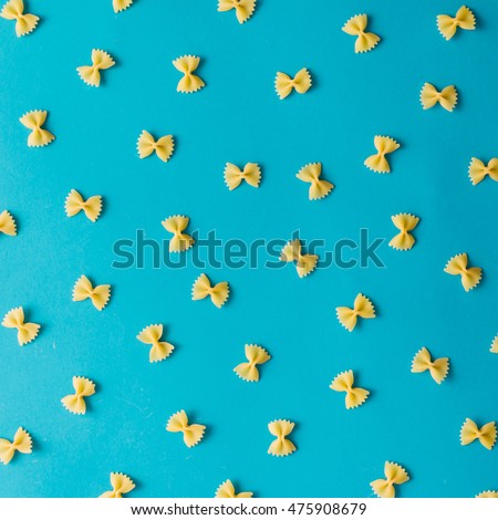 Pattern made of pasta on blue background. Flat lay.