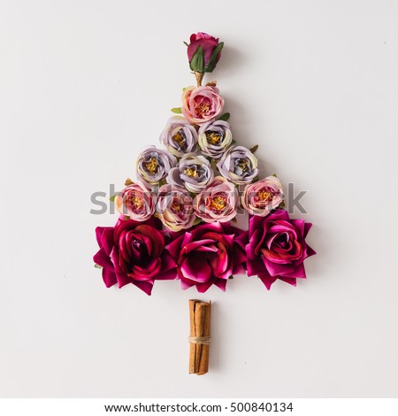 Christmas tree made of flowers and cinnamon sticks. Flat lay. Holiday concept.
