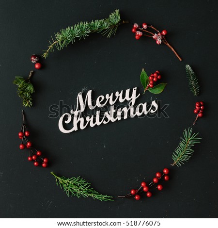 Christmas round frame made of natural winter things on dark blackboard. Flat lay. Christmas concept.
