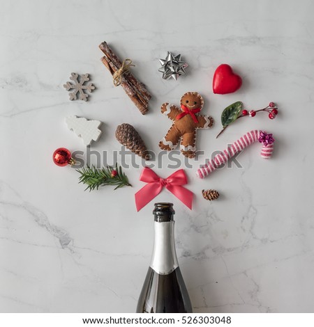 Champagne bottle with christmas decoration on marble background. Flat lay. Party concept.