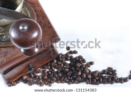 Coffee spilled grain and old coffee mill