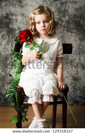 portrait of curly girl with rose