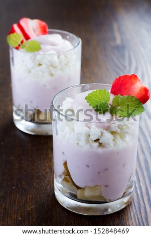 dessert from cottage cheese and fruits on a wooden background