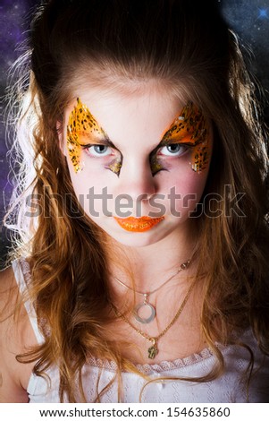 Pretty girl with face painting of sign of the zodiac Leo