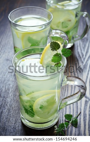 cups of green tea with mint, ginger root and a lemon