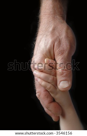 Child holds grandfather\'s weathered hands