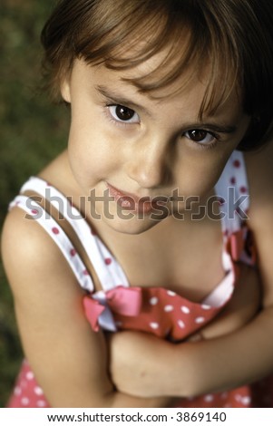 Cute Little Girl Crosses Arms (Shallow depth of Field emphasizes the eyes)