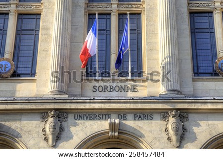 Facade of the University of Sorbonne with the flags of France and European Union