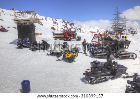 CAUCASUS, RUSSIA - May 01.2015: Snow grooming and snowmobiles next to the station of ropeway on the slope of mountain Elbrus