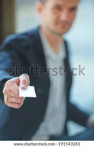 Man\'s hand showing business card