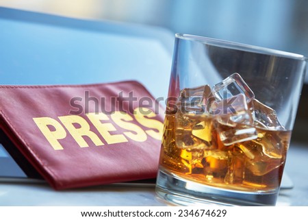 the mass media card, a glass of whiskey, tablet