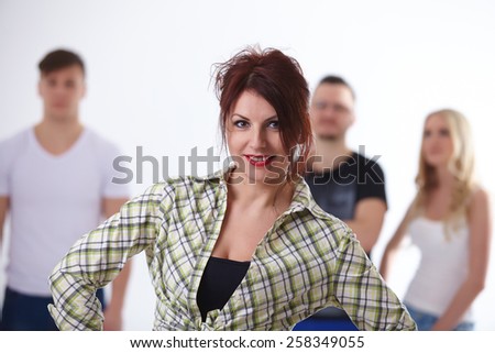 young red-haired woman on the background of the group are the students