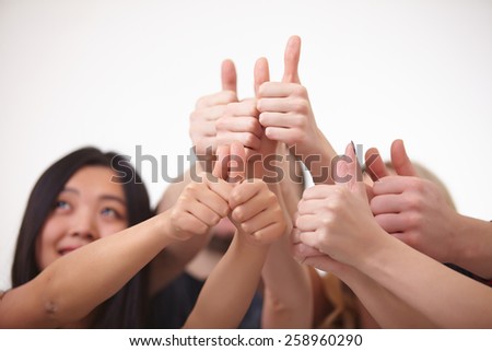 a group of young people, students stand together, show the thumb