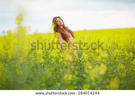 rapeseed field, yellow, red-haired naked girl standing