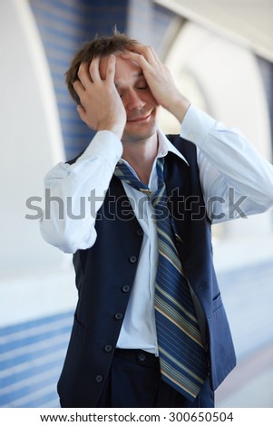 Tired businessman in loosened his tie during a break