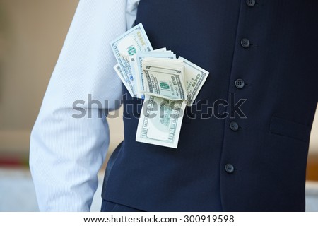 from his pocket a businessman sticking out of money