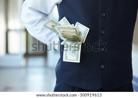 from his pocket a businessman sticking out of money