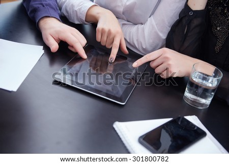 hand a group of businessmen on a table with a tablet, mobile phone