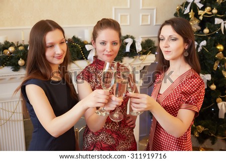 three beautiful girls on New Year's party with champagne