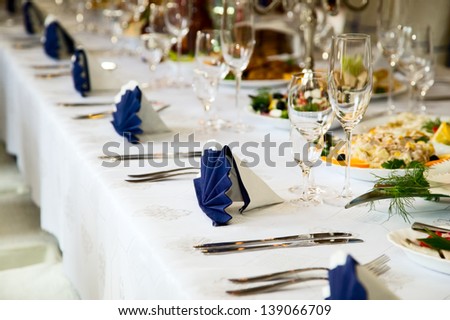 Wedding table with forks, wine glasses, knifes and food