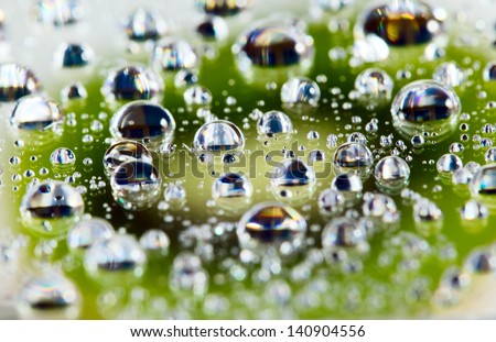 Background from green fruit kiwi with water drops, food concept