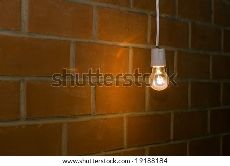 A light bulb on red brick background