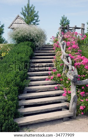 Wooden stairs with flowers and grass from both sides