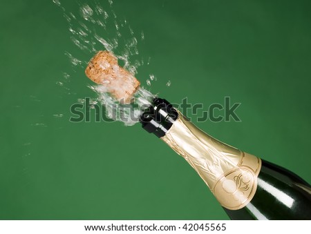 Explosion of green champagne bottle cork on background
