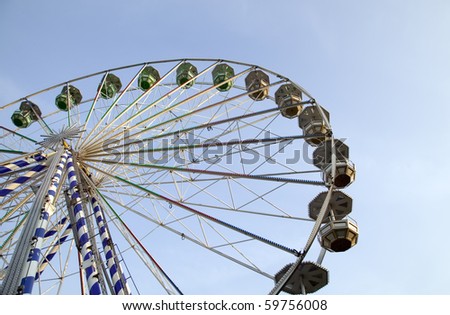 There is a big ferris wheel with sky background