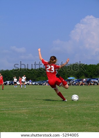 kicking soccer ball. Girl kicking soccer ball.