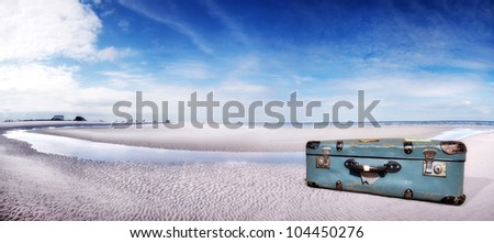 baggage at the beach, cases for holiday travel, blue sky and blue case