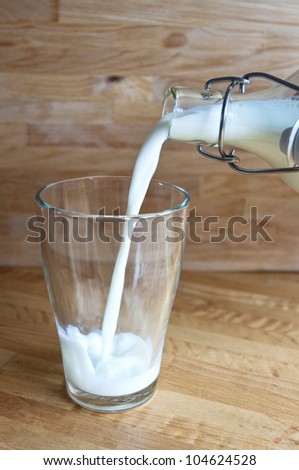 Pour milk into a glass, milky way, white fresh milk