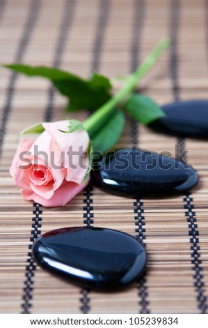 massage stones and flower, like a concept for wellness, body care and yoga symbols
