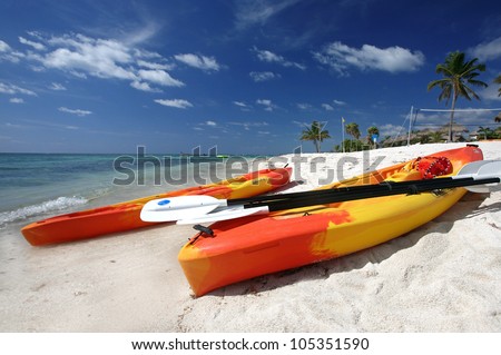 Colorful sea kayaks on a tropical beach, two kayaks