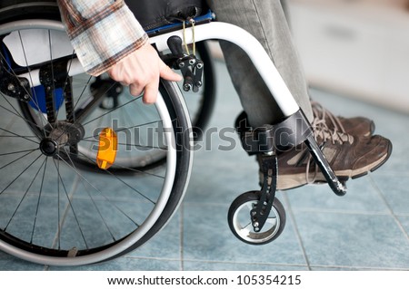 wheelchair user makes various movements with his wheelchair, exercises for safety handling