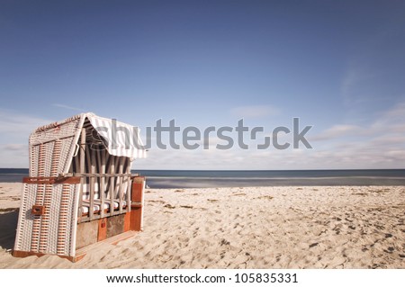 Hooded Beach chair at a beach on the baltic sea coast, beach chair at a long beach with baltic sea at background
