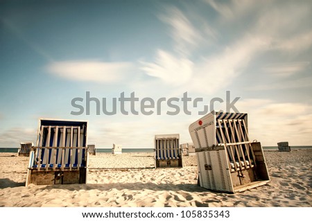 Hooded Beach chairs at a beach on the baltic sea coast, beach chairs at a long beach at baltic sea