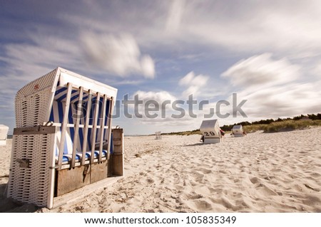 Hooded Beach chair at a beach on the baltic sea coast, beach chair with breezy sky