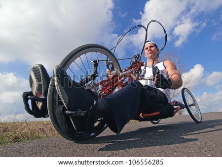 racing bike for a wheelchair user, wheelchair user on his racing bike on a summer day