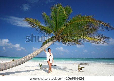 mature woman in a relaxed holiday atmosphere at a tropical white sand beach, Mexiko-Yucatan