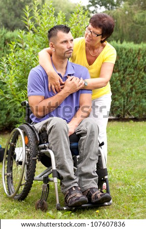 family togetherness with a mother and a disabled young man in wheelchair