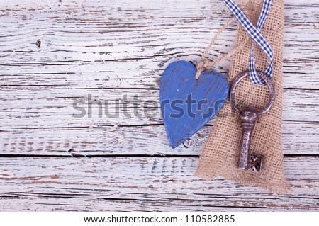 old iron key with a heart of wood is hanging on a wooden wall,  icon of valentine\'s Day
