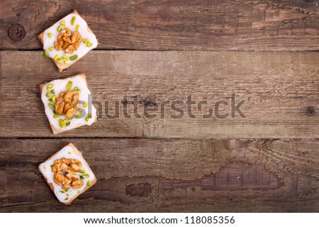 Traditional christmas cookies with walnut and pistachio nuts on a wooden board
