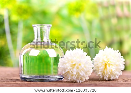 refreshing natural beauty culture, a bottle of herbal essences and two white flowers, Spa and health care concept