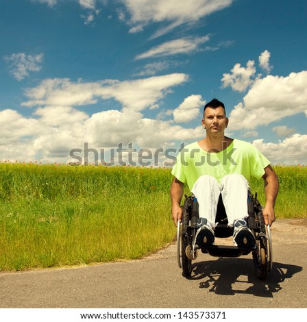 disabled Young man is moving his wheelchair on summer day, Training for moves