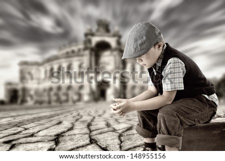 little sad boy is sitting on a case and wait for someone or something, retro style