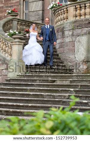 just married, wedding day Shooting in front of an old Castle, happy bride and groom on stairs