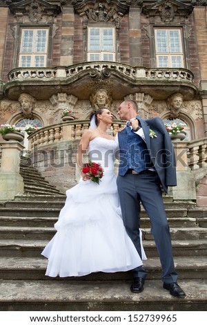 wedding day Shooting in front of an old Castle, happy bride and groom on stairs, just married