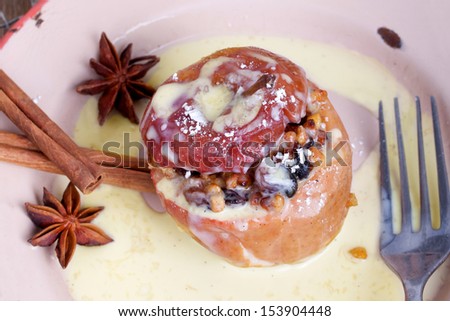 delicious dessert for traditional christmas meal, baked apples for christmas with vanilla sauce