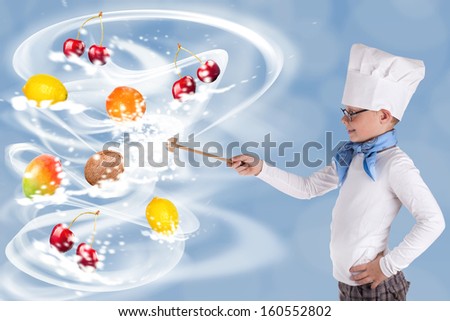 boy chef in uniform with ladle stirring for flying fruits, young boy prepares magic fruits as a warlock